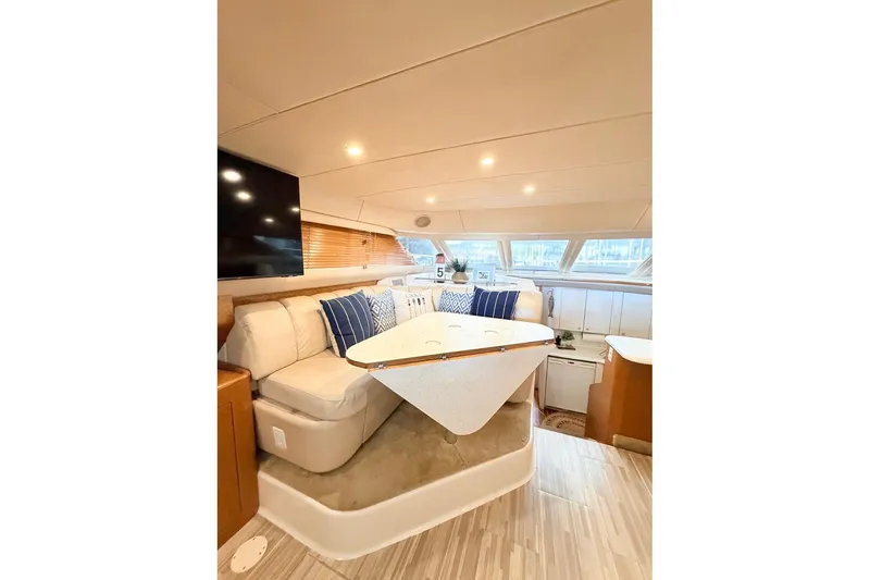 Slide: The Image of Luxurious interior of 1997 Sea Ray 420 Aft Cabin yacht with cozy seating and modern decor. - 15