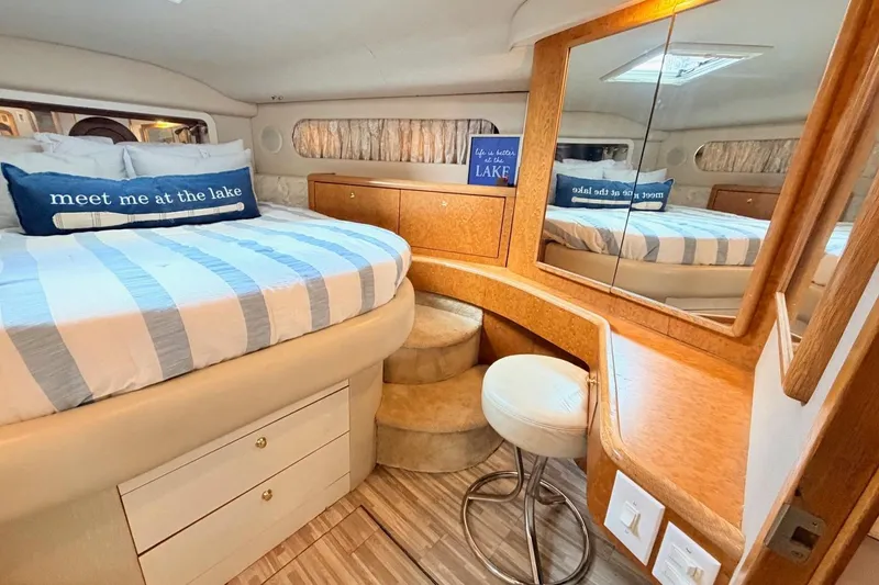 Slide: The Image of Luxurious 1997 Sea Ray 420 Aft Cabin bedroom with cozy decor and elegant furnishings. - 18