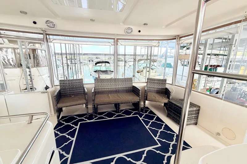 Slide: The Image of 1997 Sea Ray 420 Aft Cabin interior with wicker seating and nautical decor. - 2