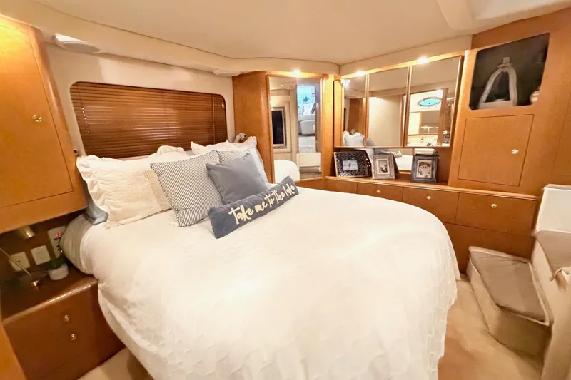 Slide: The Image of Luxurious 1997 Sea Ray 420 Aft Cabin bedroom with elegant decor and cozy bedding. - 21