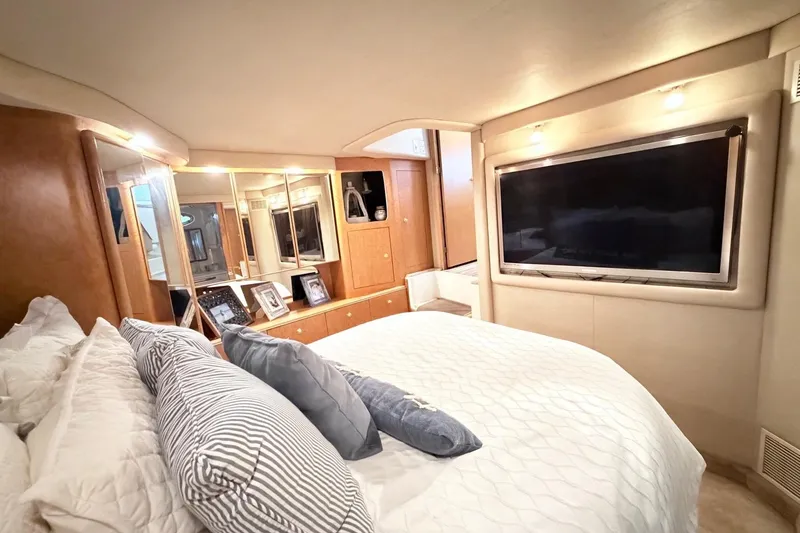 Slide: The Image of Luxurious bedroom interior of 1997 Sea Ray 420 Aft Cabin yacht with modern amenities. - 23