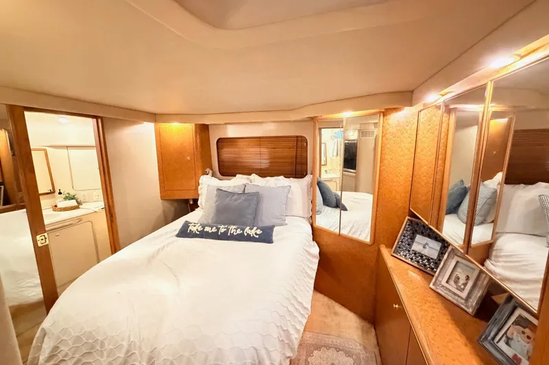 Slide: The Image of Luxurious 1997 Sea Ray 420 Aft Cabin bedroom with cozy bedding and elegant decor. - 24