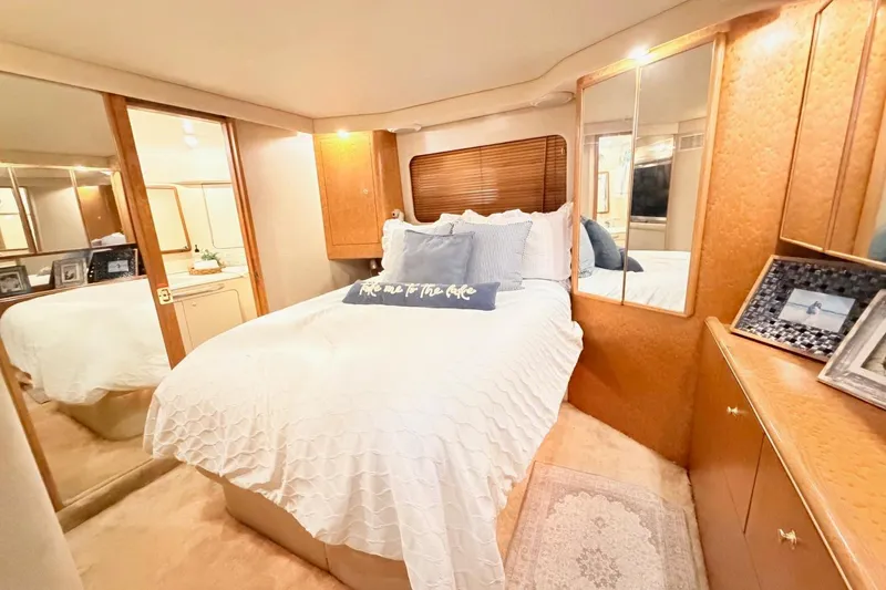 Slide: The Image of Luxurious bedroom interior of 1997 Sea Ray 420 Aft Cabin yacht with cozy bedding. - 25