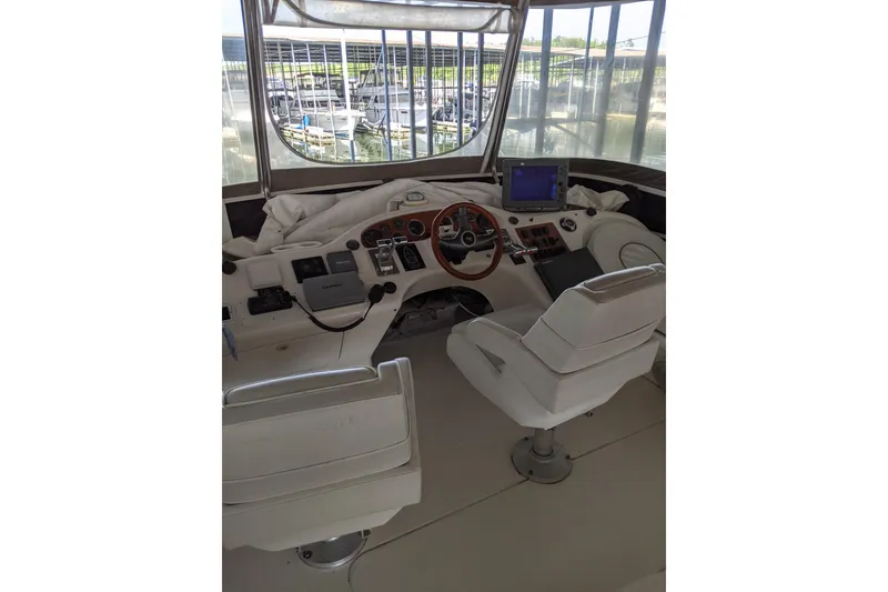 Slide: The Image of 1996 Sea Ray 420 Aft Cabin helm with dual seats and navigation equipment. - 29
