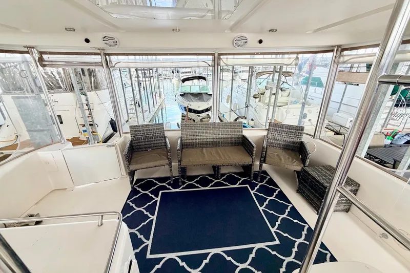 Slide: The Image of 1997 Sea Ray 420 Aft Cabin interior with wicker seating and nautical decor. - 3