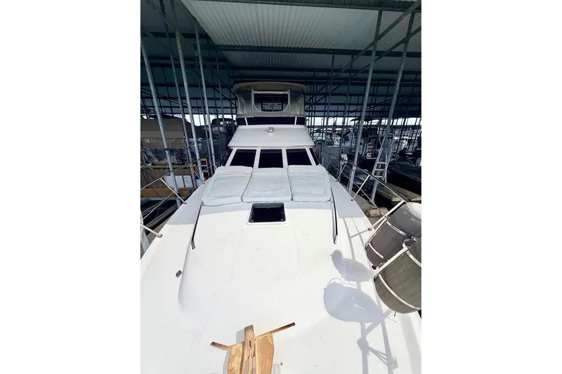 Slide: The Image of 1997 Sea Ray 420 Aft Cabin yacht docked under a covered marina. - 41