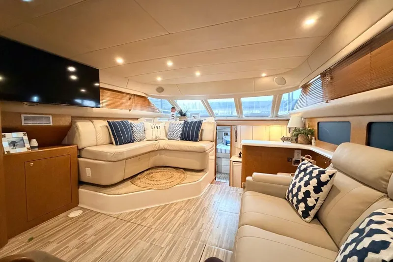 Slide: The Image of Luxurious interior of a 1997 Sea Ray 420 Aft Cabin yacht with plush seating and modern decor. - 8