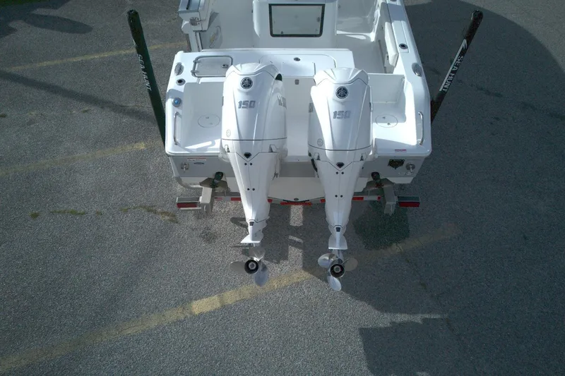 Slide: The Image of 2024 Sea Hunt Gamefish 25 boat with dual 150 horsepower outboard engines, aerial view. - 11