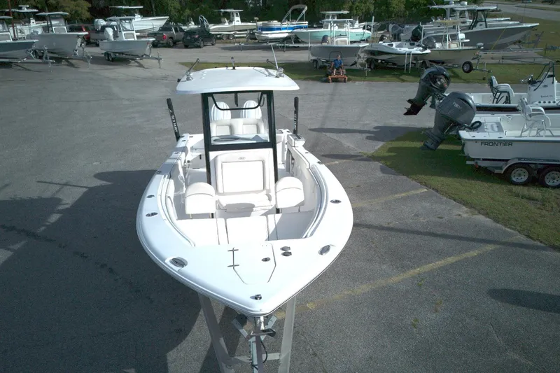 Slide: The Image of 2024 Sea Hunt Gamefish 25 boat displayed in a marina with other vessels. - 14