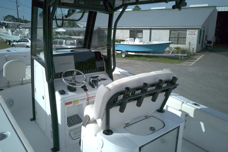 Slide: The Image of 2024 Sea Hunt Gamefish 25 boat interior with Garmin navigation system and seating. - 5