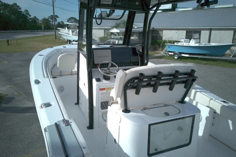 Slide: The Image of 2024 Sea Hunt Gamefish 25 boat interior with steering console and seating. - 6