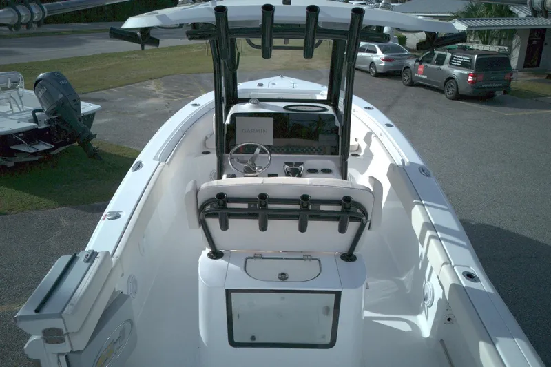 Slide: The Image of 2024 Sea Hunt Gamefish 25 boat interior with Garmin navigation system and rod holders. - 8