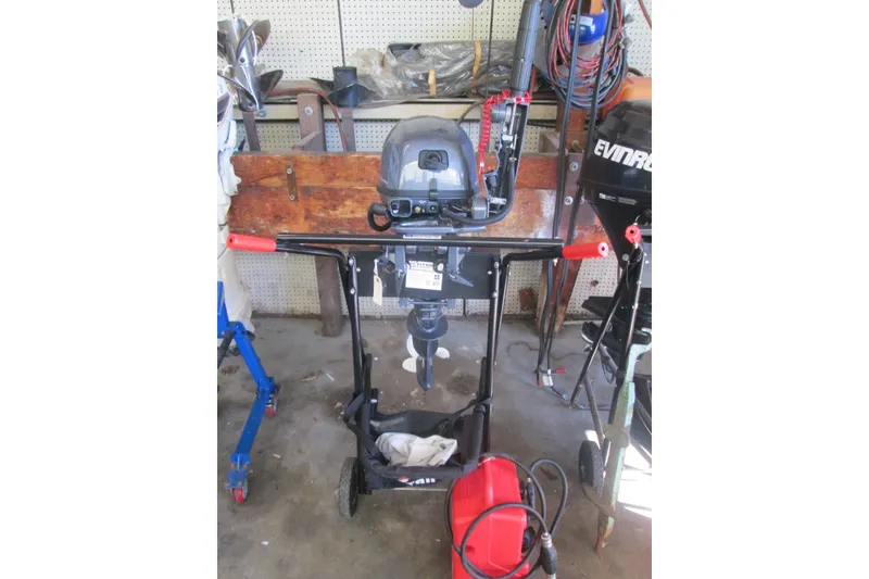 Slide: The Image of 2023 Zodiac Cadet 310 Alu outboard motor in a workshop setting. - 11