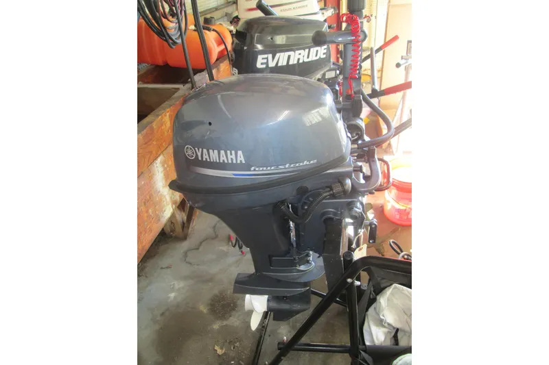 Slide: The Image of 2023 Zodiac Cadet 310 Alu with Yamaha outboard motor in a garage setting. - 2