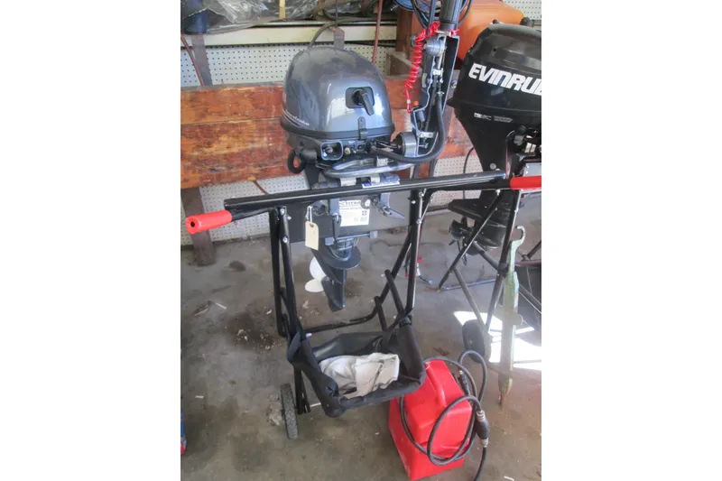 Slide: The Image of 2023 Zodiac Cadet 310 Alu outboard motor in a workshop setting. - 5