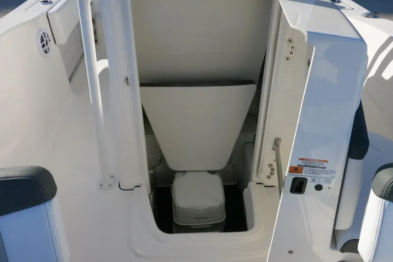 Slide: The Image of 2026 Robalo R202 Explorer boat interior with compact marine toilet. - 14