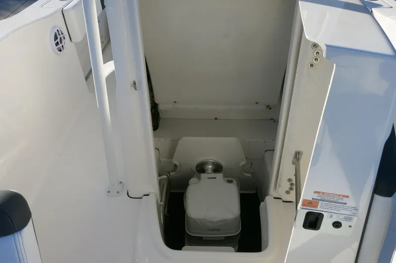 Slide: The Image of 2026 Robalo R202 Explorer boat interior with compact marine toilet. - 15