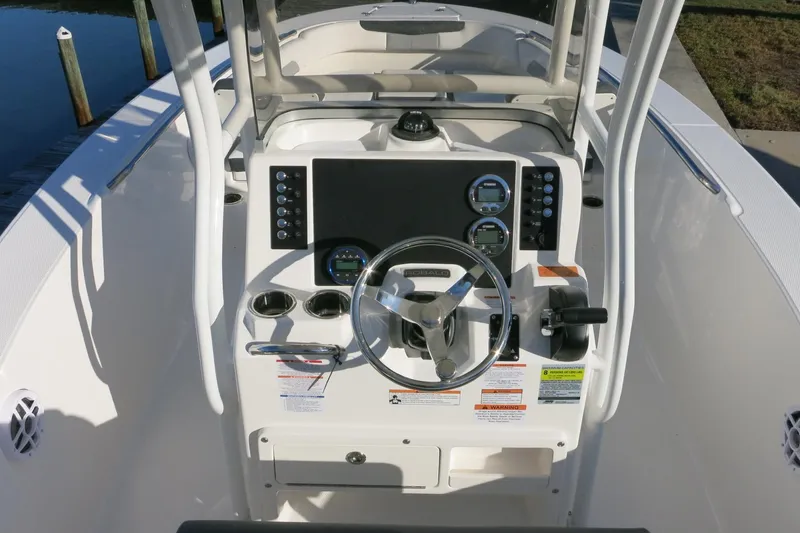 Slide: The Image of 2026 Robalo R202 Explorer boat dashboard with steering wheel and control panel. - 19