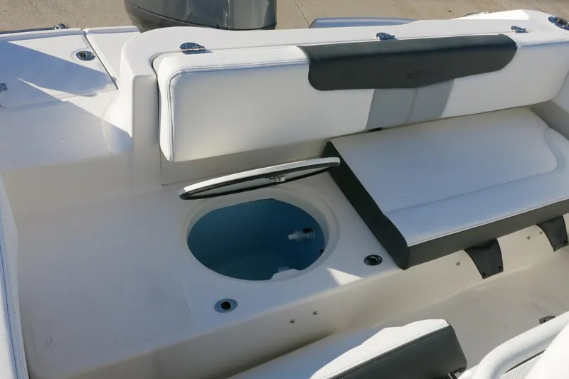 Slide: The Image of 2026 Robalo R202 Explorer boat interior with seating and storage compartment. - 21