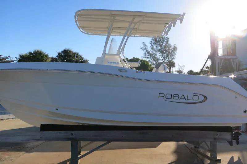 Slide: The Image of 2026 Robalo R202 Explorer boat on display, side view with sunlight. - 4