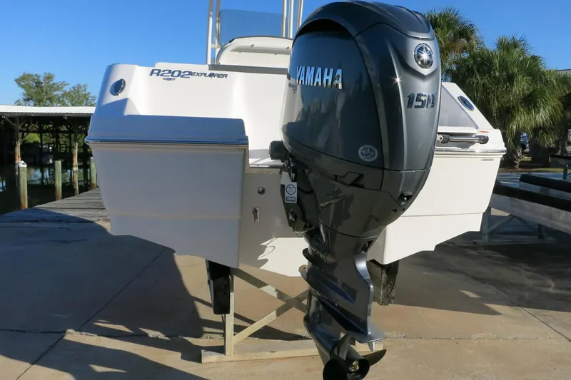 Slide: The Image of 2026 Robalo R202 Explorer boat with Yamaha 150 engine, docked outdoors. - 6