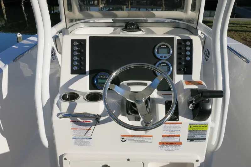Slide: The Image of 2026 Robalo R202 Explorer boat dashboard with steering wheel and control panel. - 9