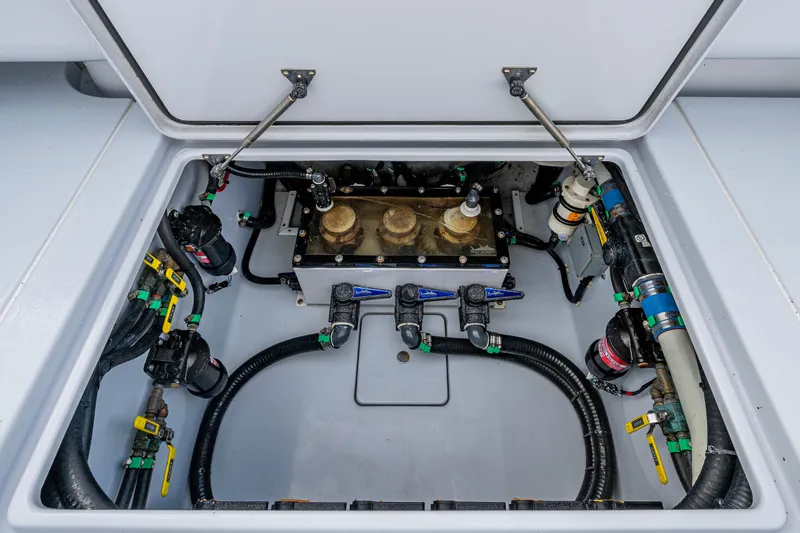 Slide: The Image of 2024 Contender 44 ST boat compartment showcasing plumbing and mechanical components. - 20
