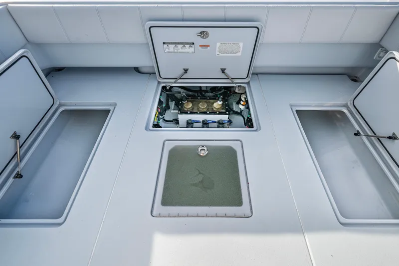 Slide: The Image of 2024 Contender 44 ST boat deck with open storage compartments and engine access. - 21