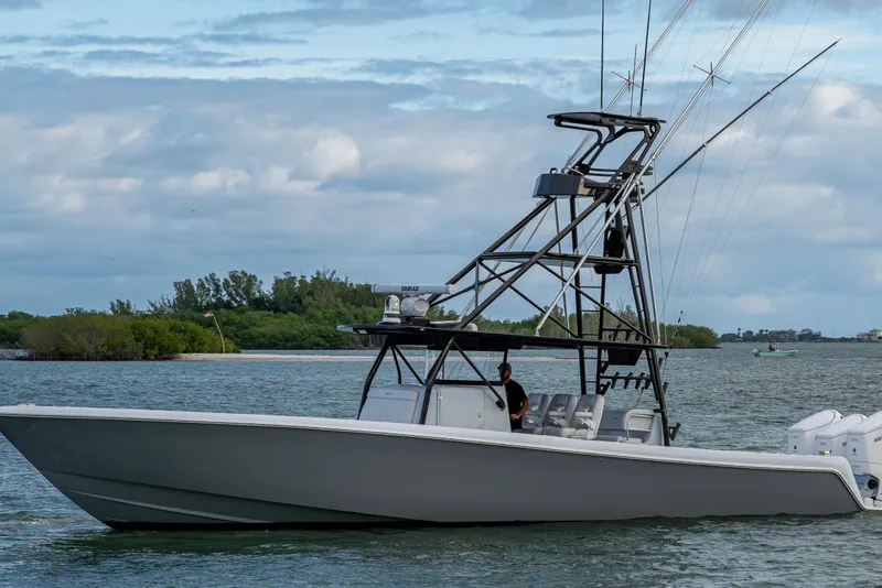 Slide: The Image of 2024 Contender 44 ST boat on water, featuring sleek design and advanced fishing tower. - 28