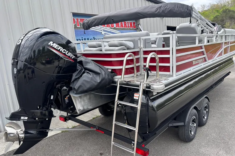 Slide: The Image of 2025 Ranger Reata 220FC pontoon boat with Mercury outboard motor on trailer. - 3