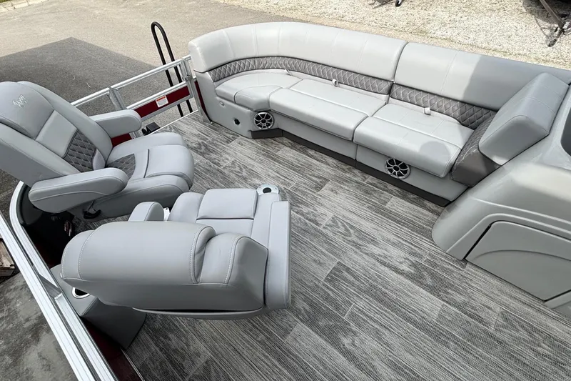 Slide: The Image of 2025 Ranger Reata 220FC boat interior with gray seating and wood-style flooring. - 6