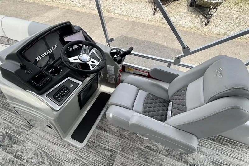 Slide: The Image of 2025 Ranger Reata 220FC boat interior with steering console and luxurious captain's chair. - 8