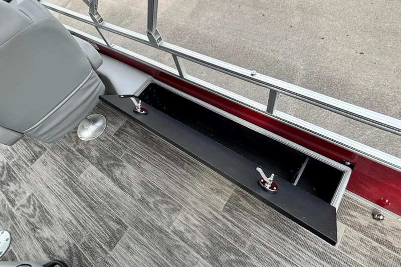 Slide: The Image of 2025 Ranger Reata 220FC boat interior with open storage compartment and seating. - 9