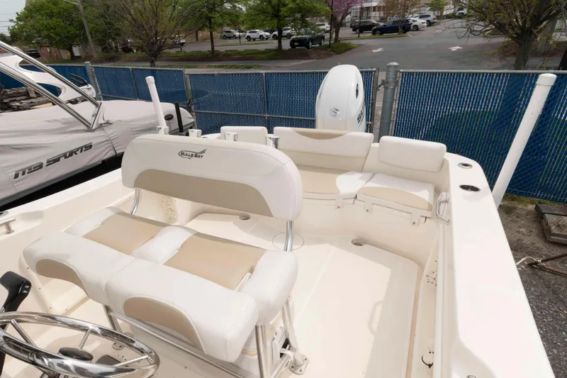 Slide: The Image of 2023 Bulls Bay 230 Center Console boat interior with seating and steering wheel. - 10