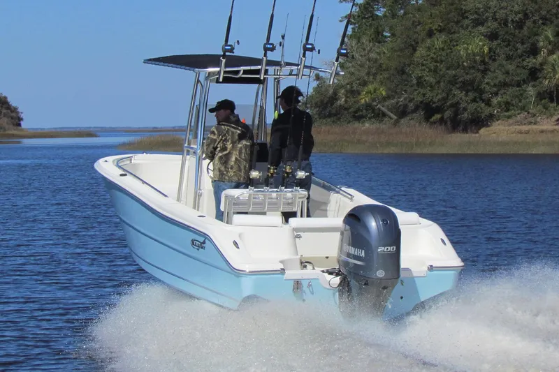 Slide: The Image of 2023 Bulls Bay 230 Center Console boat on trailer, parked outdoors under blue sky. - 2