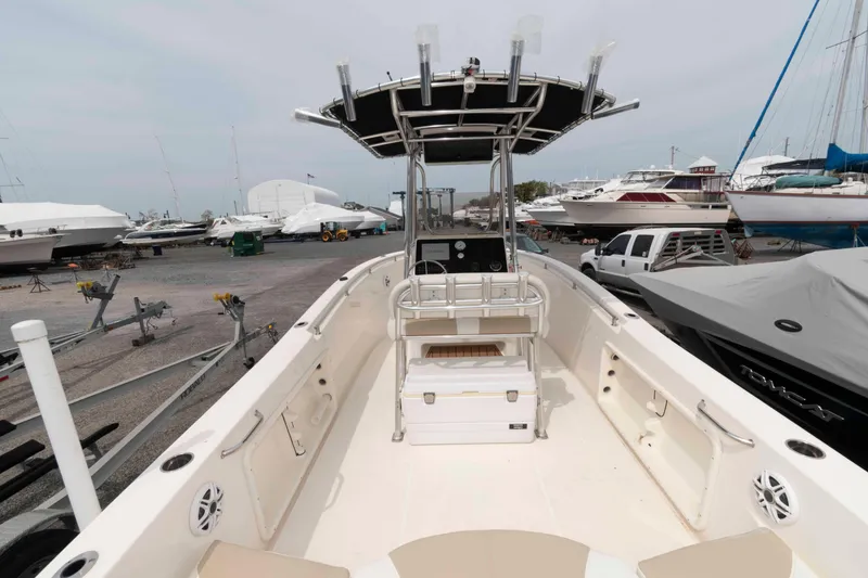 Slide: The Image of 2023 Bulls Bay 230 Center Console boat in a marina, surrounded by other vessels. - 4