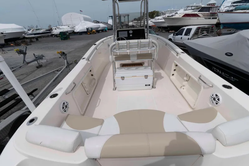Slide: The Image of 2023 Bulls Bay 230 Center Console boat interior at marina, showcasing seating and storage. - 5