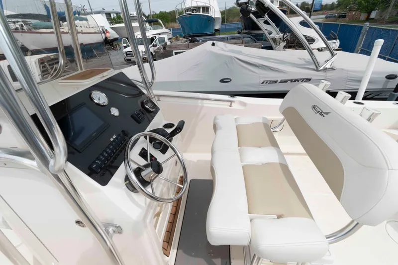 Slide: The Image of 2023 Bulls Bay 230 Center Console boat interior with steering wheel and seating. - 6