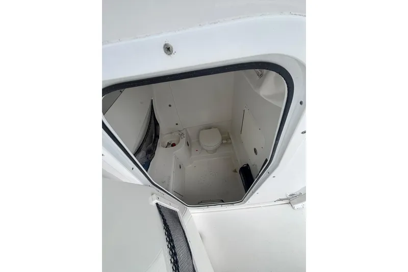 Slide: The Image of Interior view of 2017 Sea Hunt Gamefish 30 boat's compact bathroom area. - 13