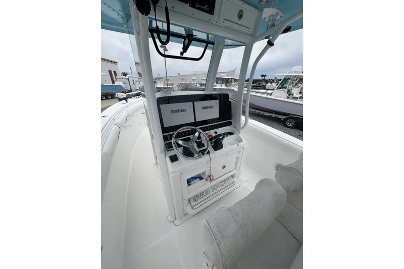 Slide: The Image of 2017 Sea Hunt Gamefish 30 boat cockpit with Simrad electronics and steering wheel. - 14
