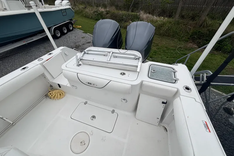 Slide: The Image of 2017 Sea Hunt Gamefish 30 boat deck with dual engines and storage compartments. - 17