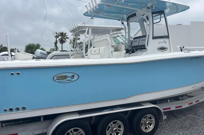 Slide: The Image of 2017 Sea Hunt Gamefish 30 boat in light blue on a trailer, side view. - 3