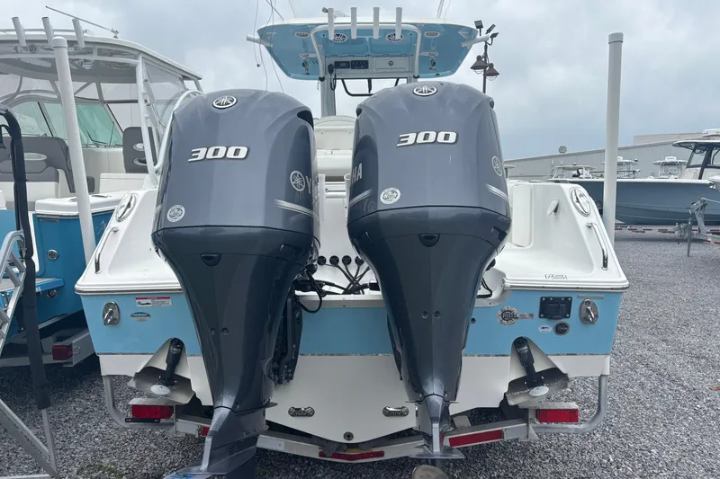Slide: The Image of 2017 Sea Hunt Gamefish 30 with dual Yamaha 300 engines, docked on gravel. - 5
