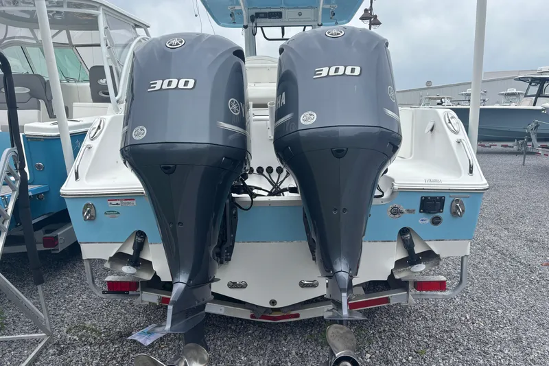 Slide: The Image of 2017 Sea Hunt Gamefish 30 with dual Yamaha 300 engines, docked on gravel. - 6