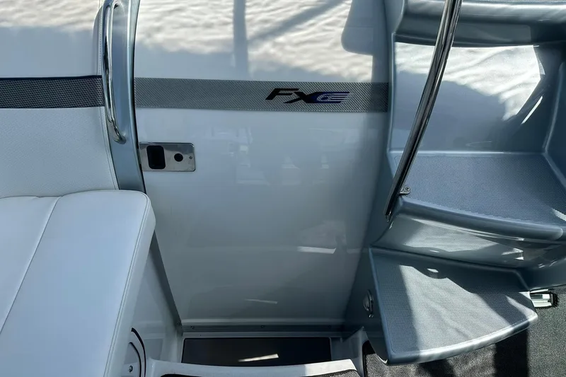 Slide: The Image of Interior view of a 2012 Formula 350 FX6 boat, featuring sleek seating and stairs. - 11