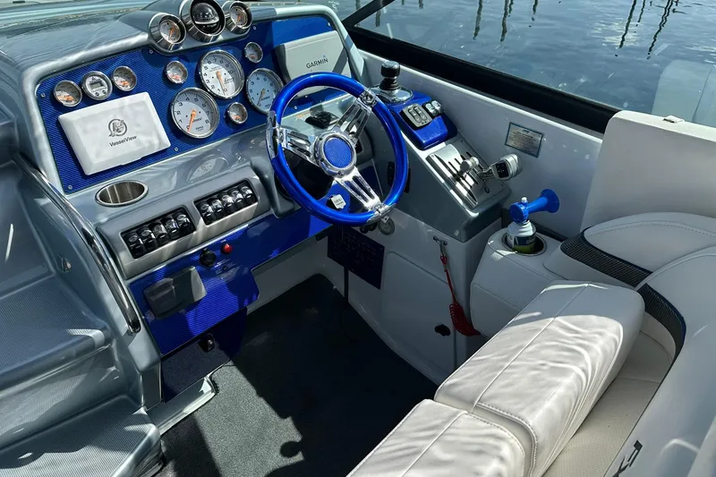 Slide: The Image of Cockpit of 2012 Formula 350 FX6 boat with blue steering wheel and control panel. - 12