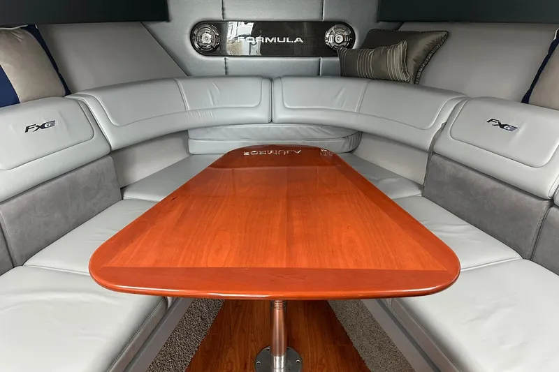 Slide: The Image of Luxurious interior of a 2012 Formula 350 FX6 boat with elegant seating and wooden table. - 17
