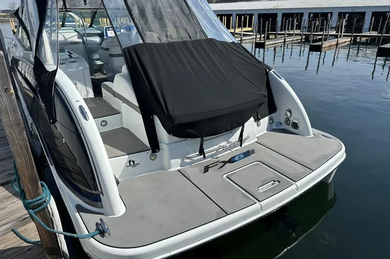 Slide: The Image of 2012 Formula 350 FX6 boat docked, featuring sleek design and covered seating area. - 5