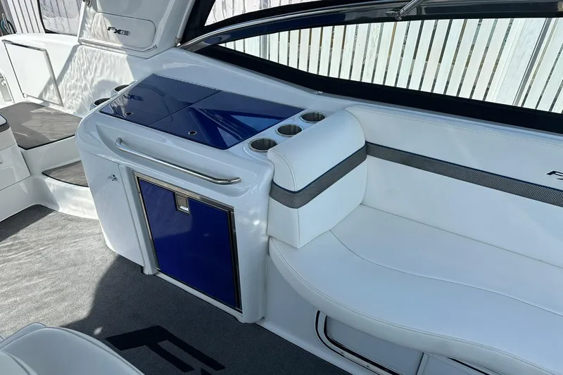 Slide: The Image of Interior of 2012 Formula 350 FX6 boat with white seating and blue accents. - 9