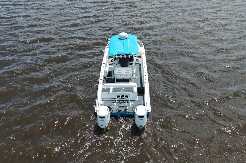 Slide: The Image of 2024 Twin Vee 240 GFX CC boat with dual engines on open water. - 11